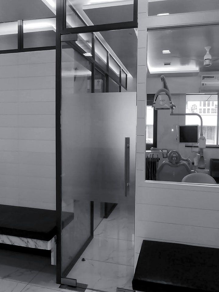 The corridor of the clinic, glass doors on either side.