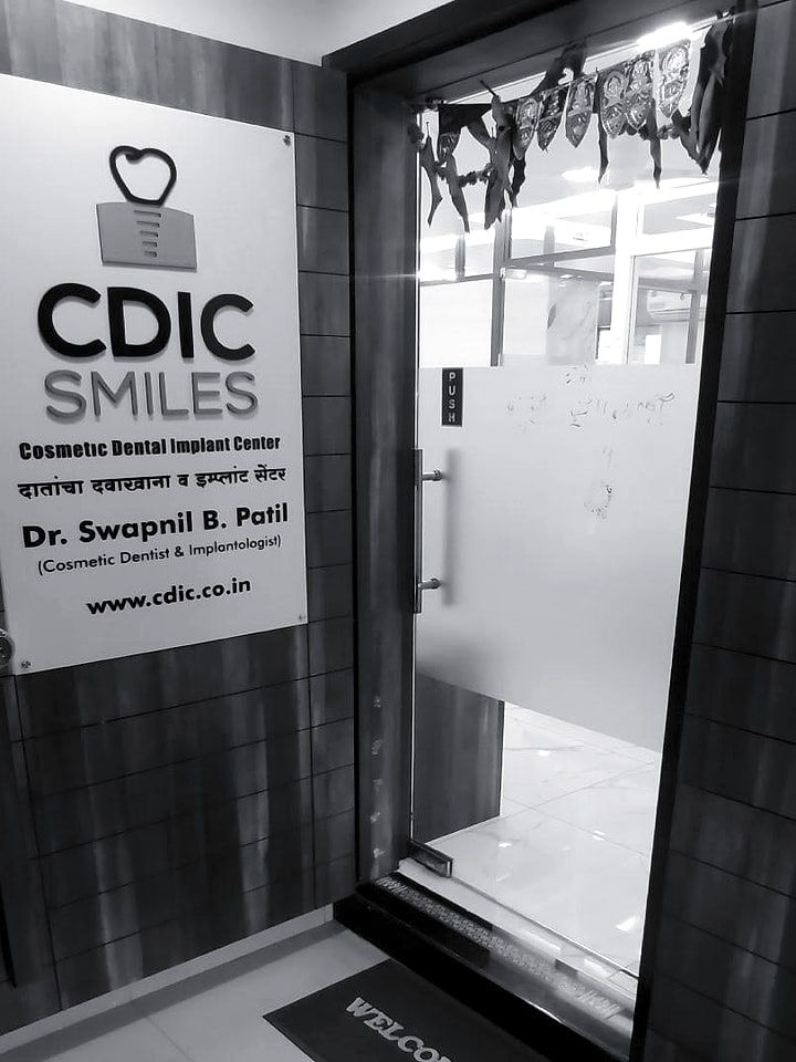 The clinic entrance, with the CDIC Smiles sign beside the door.