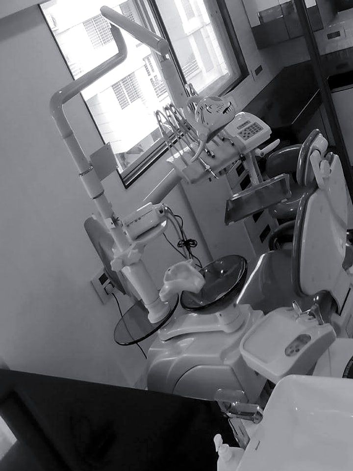 A treatment room with the dental chair and overhead light.